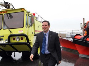 MP Jeff Watson hurries in from the rain to announce federal funding to help replace an aging and obsolete fire pumper and a new snow plow blade at Windsor Airport  Wednesday, April 10, 2013. (NICK BRANCACCIO/The Windsor Star