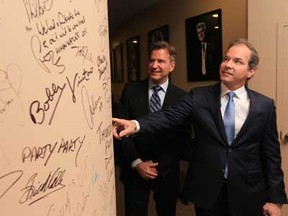 Caesars Windsor Director of Entertainment Tim Trombley, left, and President & CEO Kevin Laforet tour the green room at the Colosseum before announcing the new musical lineup that includes acts such as Journey, Peter Frampton among others. Here, they show off one of the 'Columns of Fame' which has been signed by recording artists who have performed at the Colosseum. (JASON KRYK/The Windsor Star)
