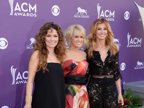 Singers Shania Twain, left, Carrie Underwood and Faith Hill arrive at the 48th Annual Academy of Country Music Awards at the MGM Grand Garden Arena on April 7, 2013 in Las Vegas, Nevada.  (Photo by Jason Merritt/Getty Images)