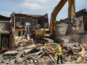 An excavator with Gagnon Demolition tears down a three-storey building at 49 Talbot S.t N. in downtown Essex, Ont., Sunday, April 21, 2013.  The building was torn down due to safety concerns.  (DAX MELMER/The Windsor Star)