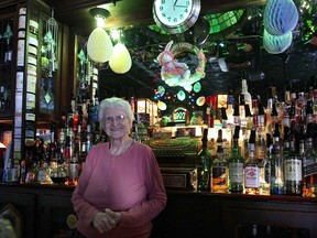 The Detroit Bus Company's Frontier Anarchy tour included stops at the Abick's bar which was established in 1907 and one of the few bars that survived prohibition. Manya Abick, 89, poses behind the bar March 30, 2013, where she has worked her whole adult life. (DAN JANISSE/The Windsor Star)