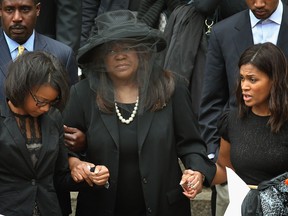 Chaz Ebert (C), the wife of film critic Roger Ebert, leaves Holy Name Cathedral following a funeral service for her husband April 8, 2013 in Chicago, Illinois. Ebert died April 4, at the age of 70, after a long battle with cancer. (Photo by Scott Olson/Getty Images)