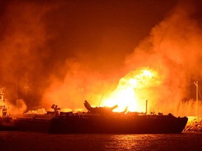 A massive explosion at 3 a.m. on one of the two barges still ablaze in the Mobile River in Mobile, Ala., on Thursday, April 25, 2013. Three people were injured in the blast. (John David Mercer / AP)