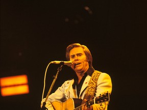 George Jones performs on stage at the Country Music Festival held at Wembley Arena, London in April 1981. (Photo by David Redfern/Redferns)