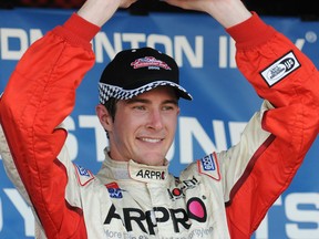 Indy Lights driver J.R. Hildebrand hoists his first-place trophy at the  Firestone Indy Lights race in Edmonton in 2009. (Walter Tychnowicz/ Edmonton Journal)