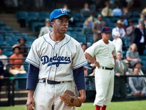 This film image released by Warner Bros. Pictures shows Chadwick Boseman as Jackie Robinson, right, and Harrison Ford as Branch Rickey in a scene from "42." (AP Photo/Warner Bros. Pictures, D. Stevens)