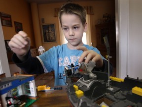Kyle Kincaid, 8, who has autism spectrum disorder plays with his toys Thursday, March 28, 2013, at his Windsor, Ont. home. (DAN JANISSE/The Windsor Star)
