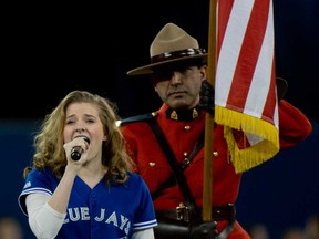 Danielle Wade of LaSalle, Ont., sings the national anthems at the Toronto Blue Jays season opener at Rogers Centre in Toronto April 2, 2013.   (Tyler Anderson/National Post)