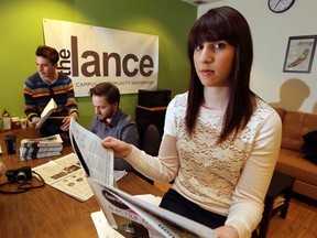 Told to immediately cease print production, The Lance staffers Stephen Hargreaves, left, Jon Liedtke and Natasha Marar take a look  Friday April 5, 2013, at the April 3, edition, and possibly the last print edition, of The Lance. (NICK BRANCACCIO/The Windsor Star)
