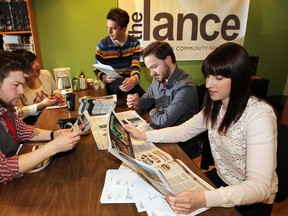 Told to immediately cease print production, The Lance staffers Jay Verspeelt, left, Jolie Inthavong, Stephen Hargreaves, Jon Liedtke and Natasha Marar take a look Friday April 5, 2013, at the latest, and possibly the last, edition of The Lance. (NICK BRANCACCIO/The Windsor Star)