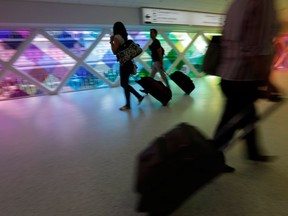 In this Thursday, Sept. 27, 2012 photo, passengers travel through an airport in Miami. Private researchers, who have analyzed federal data on airline performance, say in a report being released Monday, April 8, 2013, that consumer complaints to the Department of Transportation surged by one-fifth last year even though other measures such as on-time arrivals and mishandled baggage show airlines are doing a better job. "The way airlines have taken 130-seat airplanes and expanded them to 150 seats to squeeze out more revenue I think is finally catching up with them,” says Dean Headley, a business professor at Wichita State University, who has co-written the annual report for 23 years. (AP Photo/Lynne Sladky)