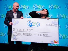 Greg McKenzie, VP of Lottery at OLG, presents a cheque for $40 million to Maria Carreiro after she won the April 5, 2013 LOTTO MAX jackpot. (CNW Group/OLG)