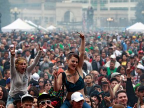 Members of a crowd numbering tens of thousands smoke marijuana and listen to live music, at the Denver 420 pro-marijuana rally at Civic Center Park in Denver on Saturday, April 20, 2013. Even before the passage in November 2012 of Colorado Amendment 64 promised the legalization of marijuana for recreational use, April 20th has for years been a celebration of marijuana counterculture, and the 2013 Denver rally draw larger crowds than previous years. (AP Photo/Brennan Linsley)