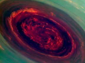 This false-color image from NASA's Cassini spacecraft and provided by NASA/JPL shows stunning views of a monster hurricane at Saturn's North Pole. The eye of the cyclone is an enormous 1,250 miles across. That's 20 times larger than the typical eye of a hurricane here on Earth. The hurricane is believed to have been there for years.This image is among the first sunlit views of Saturn's north pole captured by Cassini's imaging cameras. (AP Photo/NASA/JPL-Caltech/SSI)