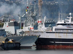 The American Seafood Company vessel American Dynasty (right) collides with the docked HMCS Winnipeg which has just undergone a massive refit and upgrade in Esquimalt, B.C., Tuesday April 23, 2013. (Chad Hipolito / The Canadian Press)