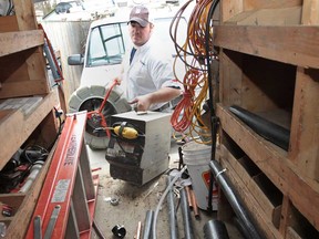 In this file photo, John Bondy of CJ Bondy Plumbing, is shown Tuesday, April 9, 2013, at the Amherstburg, Ont. business he operates with his father Chuck Bondy. They are among the 150,000 tradespeople in the province who now have to start paying increased licensing fees to the Ontario College of Trades. (DAN JANISSE/The Windsor Star)