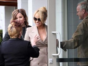 Pamela Anderson, right, arrives for her Auntie VieÍs funeral in Victoria on Tuesday, April 2, 2013.
(Photograph by: ADRIAN LAM , Times Colonist)