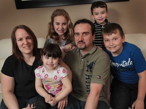 Matt Kimmerly is pictured Wednesday, April 10, 2013, at his Tecumseh, Ont. home with his wife Tricia and children Hailey, 13, Austin, 9, Logan, 5, and Vanessa, 3. He is suffering from early-onset Parkinson's disease and was diagnosed at 34 years of age. (DAN JANISSE/The Windsor Star)