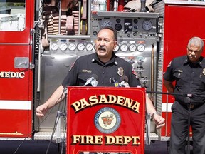 Art Hurtado, Pasadena Fire captain and paramedic takes questions during a news conference in Pasadena, Calif., Thursday, April 11, 2013. At right, Calvin Wells Pasadena Fire Chief. Hurtado helped save the life of a man at Home Depot after the victim apparently tried to cut his arms off using handsaws found at the home improvement store in West Covina, Calif. With help from police and store employees, Hurtado who was off-duty collected rope and rags from store shelves and put makeshift tourniquets on both arms, most likely saving the man's life, police said. (AP Photo/Damian Dovarganes)