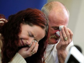 In this May 16, 2012 file photo, Mick Philpott, right, and wife Mairead react during a news conference at Derby Conference Centre following a fire at their home which claimed the lives of six of his children, Derby, England. A judge sentenced the Mick Philpott father of six children who died in a house fire to a minimum of 15 years in prison Thursday April 4, 2013, after describing him as the “driving force” behind the blaze. Judge Kathryn Thirlwall leveled most of the responsibility for the fire on Mick Philpott, describing him as a dangerous man. His wife, Mairead, Philpott received 17 years for manslaughter as did a family friend, Paul Mosley, who helped in the plot. (AP Photo/PA, Rui Vieira, File)
