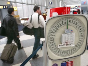 Travellers walk past a baggage scale at O'Hare International Airport in Chicago, Illinois. (Getty Images)