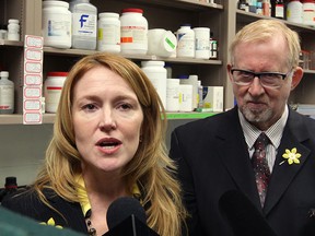 Researcher and scientist Dr. Lisa Porter, left, of the University of Windsor Biology faculty has been awarded Canadian Cancer Society funding, announced by Dr. Martin Kabat, right, to study brain cancer Wednesday April 3, 2013. (NICK BRANCACCIO/The Windsor Star)