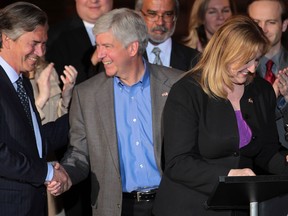Michigan Gov. Rick Snyder (C) shakes hands with Gary Doer, Ambassador of Canada to the United States as Lisa Raitt, Canada's Labour Minister prepares to speaks to speak Friday, April 12, 2013, in Detroit, MI. Snyder announced a key permit to build a second bridge linking the United States and Canada from Detroit to Windsor. (DAN JANISSE/The Windsor Star)