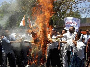 Opposition Congress party activists burn an effigy of Madhya Pradesh state chief minister Shivraj Singh Chauhan as they protest after a five-year-old girl died after being raped in Bhopal, India, Tuesday, April 30, 2013. The girl suffered cardiac arrest and died late Monday at a hospital in Nagpur city in neighboring Maharashtra state where she was being treated for injuries from the April 18 assault. India has seen a recent sharp rise in the numbers of rapes and sexual crimes against women and children. Officials said the spike has resulted from more people reporting the crimes. (AP Photo/Rajeev Gupta)