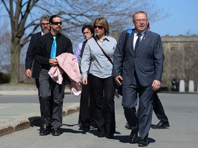 Nova Scotia Premier Darrell Dexter, right, arrives on Parliament Hill with Leah Parsons, middle right, mother of Rehtaeh Parsons and her partner Jason Barnes as well as her father Glen Canning, back left, and wife Krista, back right, in Ottawa on Tuesday, April 23, 2013. They are on Parliament Hill to discuss the Rehtaeh Parsons case with Prime Minister Stephen Harper. THE CANADIAN PRESS/Sean Kilpatrick