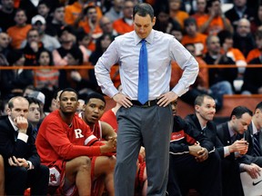 In this Jan. 2, 2013 file photo, Rutgers head coach Mike Rice reacts after Syracuse scored late in the second half of an NCAA college basketball game in Syracuse, N.Y. Rutgers has fired Rice after a videotape aired showing him shoving, grabbing and throwing balls at players in practice and using gay slurs during practice. With mounting criticism on a state and national level, the school decided to take action on Wednesday, April 3, 2013. relieving Rice of his duties after three largely unsuccessful seasons at the Big East school. (AP Photo/Kevin Rivoli, File)