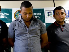 (L-R) Wallace Aparecido Silva, Carlos Armando Costa dos Santos and Jonathan Froudakis de Souza, who allegedly raped a foreign tourist in a minibus in Rio de Janeiro on March 30, 2013 are presented to the press in Rio on April 2, 2013. The three are accused of the rape of an American student who was assaulted as her French boyfriend was forced to look on during a horrific six-hour abduction aboard a Rio minibus, local media reported. AFP PHOTO/VANDERLEI ALMEIDA