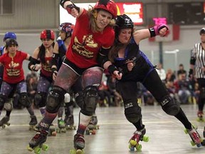 Bethany Kait, right, of the Windsor Border City Brawlers, pushes Pixie Kix of the London FC Timber Rollers during a match Saturday, April 6, 2013 at Forest Glade Arena. (THE WINDSOR STAR/ Kristie Pearce)