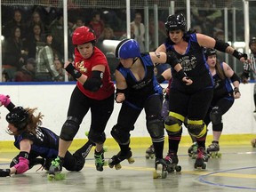 Bethany Kait, left, of the Windsor Border City Brawlers, falls while teammate Valerie Binder, centre, skates during a match against the London FC Timber Rollers Saturday, April 6, 2013 at Forest Glade Arena. (THE WINDSOR STAR/ Kristie Pearce)