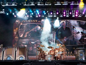 From left, Rush guitarist Alex Lifeson, drummer Neil Peart and lead signer and bassist Geddy Lee, perform on July 15, 2010 in Quebec City. THE CANADIAN PRESS/Jacques Boissinot