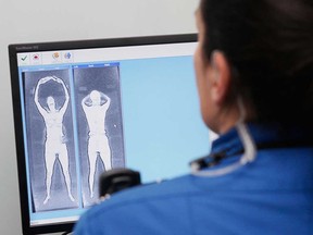 Newer full-body scanners will avoid showing silhouettes of travellers' bodies, as above, in favour of simple stick figures. (Scott Olson/Getty Images files)