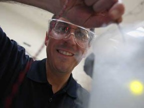 Steven J. Rehse, an assistant professor in the physics department at the University of Windsor, places a household LED light into a container of liquid nitrogen to explain how temperature can change the colour of light, while at the U of W's annual Research Showcase and Outreach Community Event at Devonshire Mall, Saturday, April 27, 2013.  (DAX MELMER/The Windsor Star)