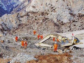 In this photo provided by China's Xinhua News Agency, rescuers work at the site where a landslide hit a mining area in Maizhokunggar County of Lhasa, capital of southwest China's Tibet Autonomous Region, Saturday, March 30, 2013. Rescuers in mountainous Tibet digging for victims of the massive landslide at a gold mining site found one body Saturday, a day after 83 workers were buried in the disaster, Chinese state media reported. The fate of the other victims was unknown. (AP Photo/Xinhua, Zhang Quan)