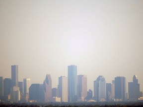 This Oct. 2, 2008 file photo show smog shrouding downtown Houston. Houston residents now can have in their pocket the answer to whether ozone levels in the city are too high for their asthmatic child to play soccer. A new app available for iPhones and Android smartphones collects data from 74 air and wind monitors throughout the Houston area, giving residents nearly real-time data on smog. (AP Photo/David J. Phillip, File)