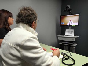 Using telemedicine video equipment, patient Massimo Iafrate and his wife, Sylvine Iafrate, left, speak with cardiovascular surgeon Dr. Tirone E. David, who was at Toronto General Hospital, Wednesday April 24, 2013.   (NICK BRANCACCIO/The Windsor Star)
