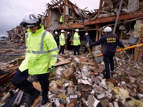 Firefighters conduct a search and rescue of an apartment building destroyed Wednesday by an explosion at a fertilizer plant in West, Texas, Thursday, April 18, 2013. (AP Photo/LM Otero)