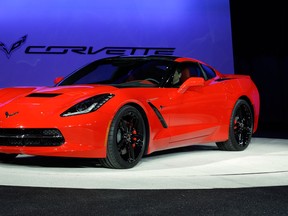 In this Jan. 14, 2013 file photo, the 2014 Chevrolet Corvette Stingray is revealed at media previews for the North American International Auto Show in Detroit. GM says a base model of the Corvette Stingray will start at just under $52,000, including a $995 shipping charge, when the all-new version goes on sale this summer. (AP Photo/Paul Sancya, File)