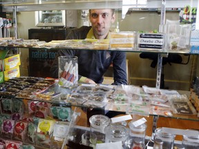 This Thursday, April 11, 2013, photo shows Matt Brown, co-owner of Denver's new "My 420 Tours," looking over a sampling of marijuana edibles at a dispensary in Denver. "My 420 Tours," gives traveling pot users everything but the drug. Brown has sold 160 tour packages to visiting pot smokers for the April 20 weekend. Prices start at $499, not including hotel or air. Instead, the service plans to pick up marijuana tourists at the airport in limousines, escort them to Cannabis Cup and other Denver-area marijuana celebrations and take them to a cannabis-friendly hotel (a national chain that has given permission for Denver patrons to smoke marijuana on outdoor patios but doesn't want its name advertised). (AP Photo/Ed Andrieski)