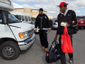 Windsor Express basketball team members Eric Parker, left, and Daniel Rose, right, board an airport shuttle on their way to Game 5 of their playoff series against Summerside Storm Monday April 01, 2013. (NICK BRANCACCIO/The Windsor Star)