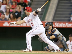 Angels slugger Albert Pujols, left,  hits a single in the first inning against the Detroit Tigers at Angel Stadium in Anaheim. Alex Avila is the TIgers' catcher in the picture. (Photo by Stephen Dunn/Getty Images)