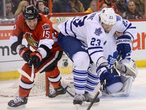 Toronto's Ryan O'Byrne, right, is checked by Ottawa's Zack Smith during the first period Saturday in Ottawa. (THE CANADIAN PRESS/Justin Tang)