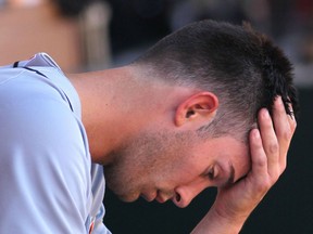 Tigers starting pitcher Rick Porcello sits in the dugout after being pulled from the game in the first inning after giving up nine runs against the Los Angeles Angels. (Photo by Victor Decolongon/Getty Images)