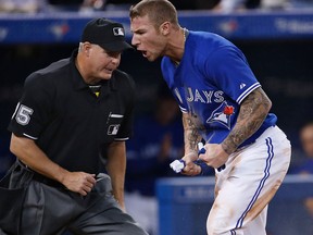 Toronto's Brett Lawrie, right, reacts after scoring a run in the sixth inning on an RBI single by Melky Cabrera against the New York Yankees at Rogers Centre in Toronto. (Photo by Tom Szczerbowski/Getty Images)
