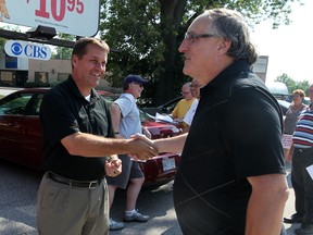Greg Prymack, left, shakes the hand of former Spits announcer Bill Kelso. (NICK BRANCACCIO/The Windsor Star)
