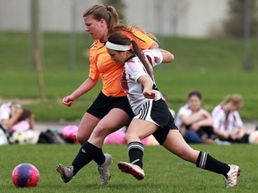 Sandwich's Jenny Day, left, battles Tess Roberts of Essex during high school girls soccer in LaSalle Tuesday.        (TYLER BROWNBRIDGE/The Windsor Star)
