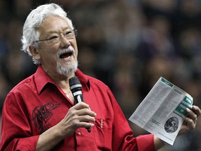 Environmentalist. author and broadcaster David Suzuki, holds a decades old warning from Union of Concerned Scientists during his address to a large audience of students at WFCU Cenrtre for a live broadcast by TVCogeco Thursday April 25, 2013.  (NICK BRANCACCIO/The Windsor Star)